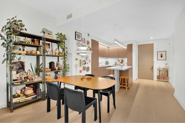 dining area with light hardwood / wood-style flooring