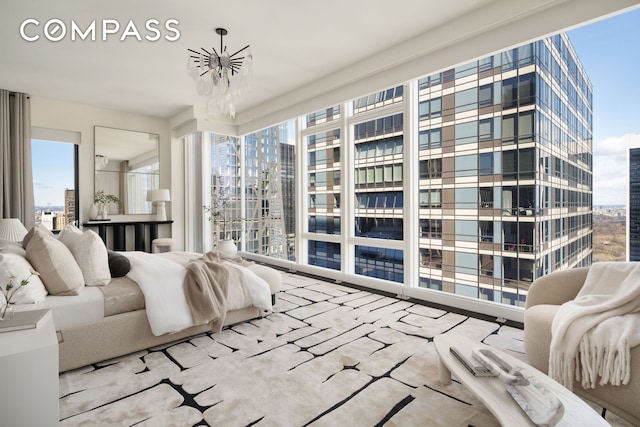 bedroom featuring a notable chandelier and floor to ceiling windows