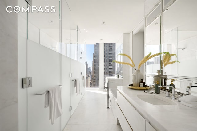 full bath with a stall shower, a view of city, vanity, and expansive windows