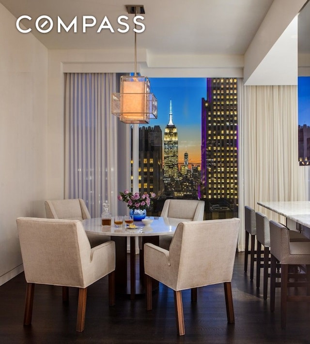 dining area featuring a view of city and wood finished floors