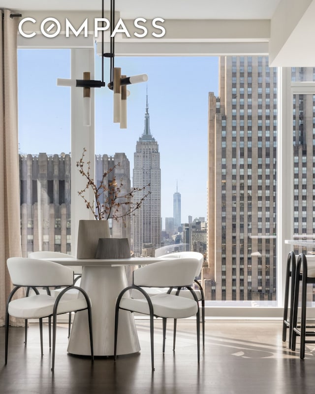 dining space with a city view and wood finished floors