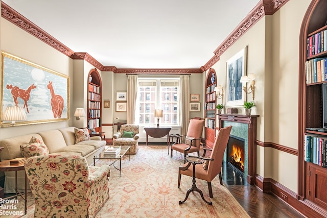 living area with a high end fireplace, crown molding, and parquet flooring