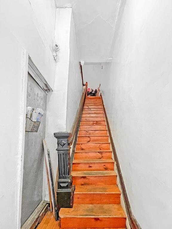 staircase with hardwood / wood-style flooring