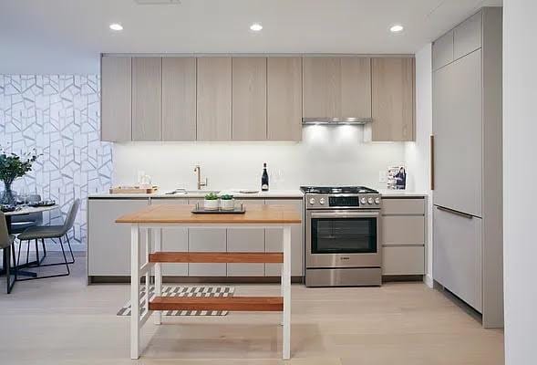 kitchen featuring gray cabinets, gas stove, and sink