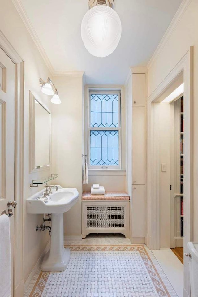 bathroom featuring radiator heating unit, baseboards, and ornamental molding