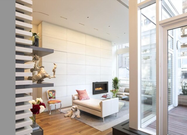 interior space featuring expansive windows, a large fireplace, and wood finished floors