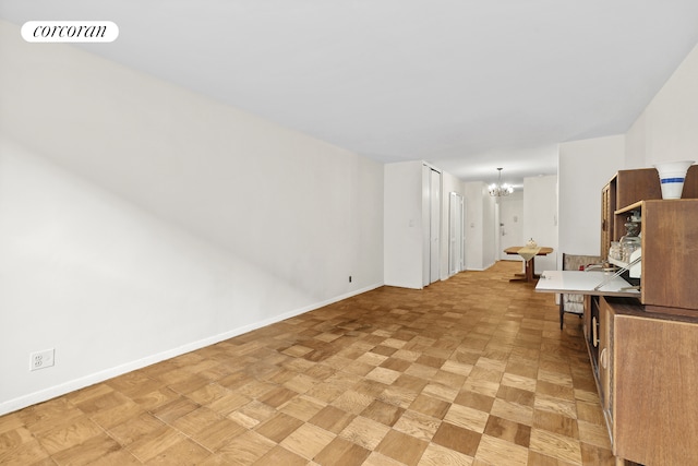 interior space featuring visible vents, baseboards, and a notable chandelier