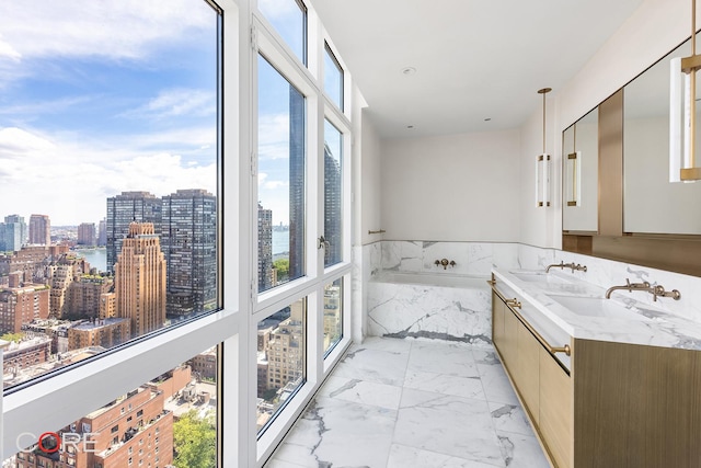 bathroom featuring a sink, wainscoting, a city view, a bath, and marble finish floor