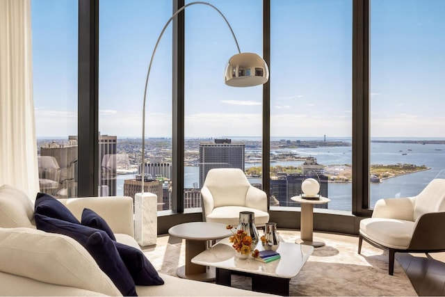 interior space featuring a water view, floor to ceiling windows, and a wealth of natural light