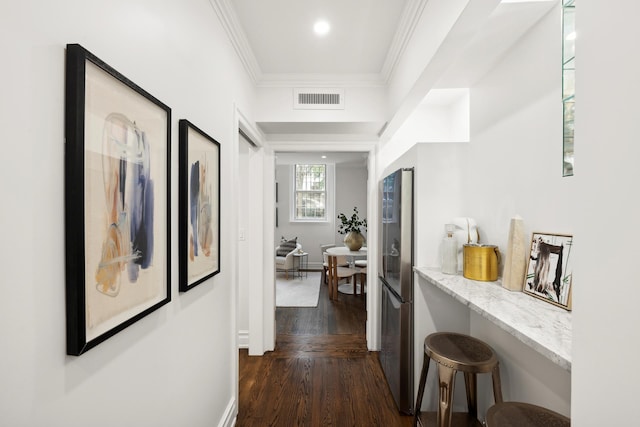 hallway with crown molding and dark hardwood / wood-style floors