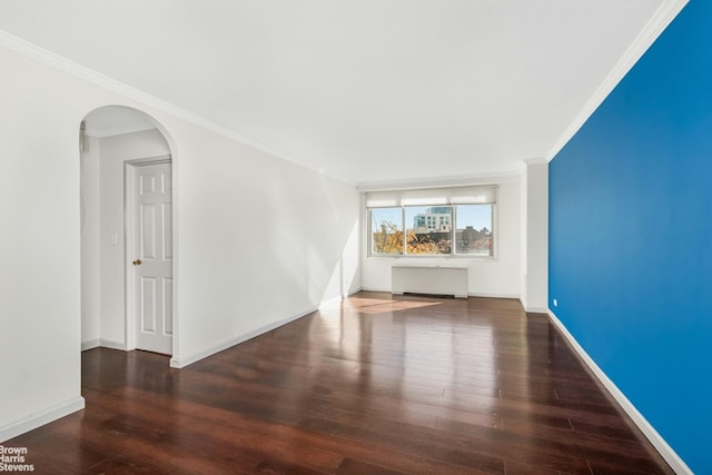 unfurnished living room with dark wood-type flooring, ornamental molding, and radiator