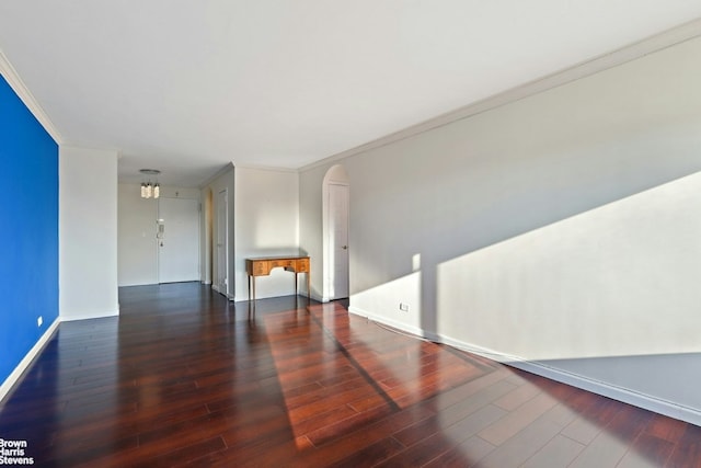 unfurnished room with dark wood-type flooring and ornamental molding