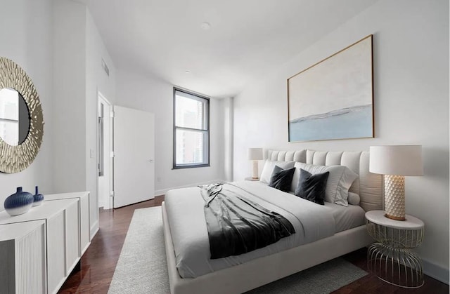 bedroom with dark hardwood / wood-style floors