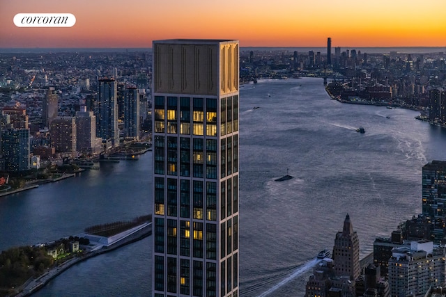 exterior space featuring a water view and a city view