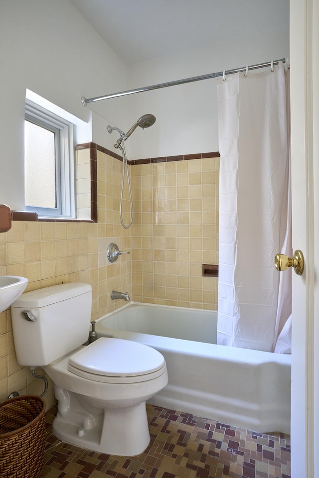 bathroom with toilet, tile patterned flooring, shower / bathtub combination with curtain, and tile walls