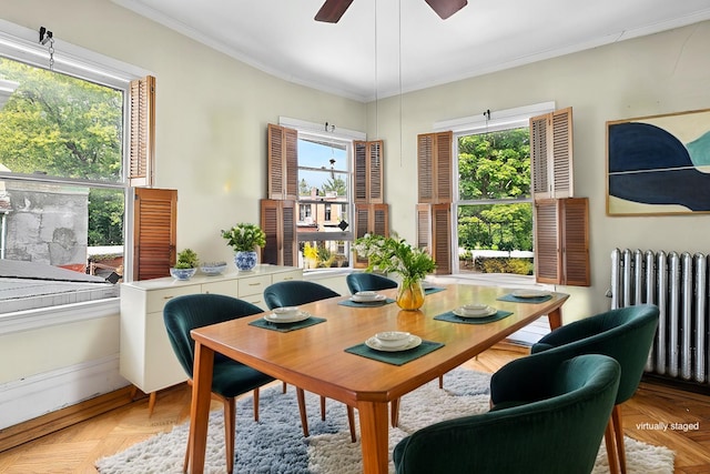 dining space featuring crown molding, radiator, and ceiling fan