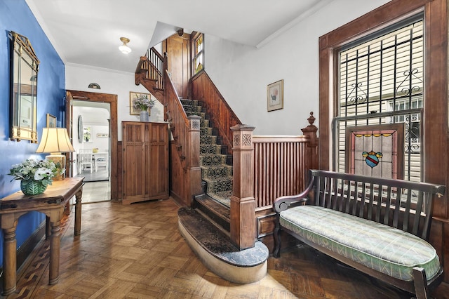 241 Fenimore St, New York City, NY 11225 - entrance foyer featuring ornamental molding, stairway, and wainscoting