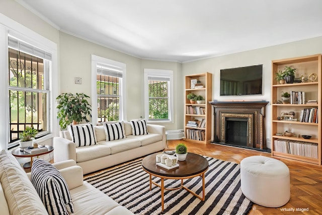 living room featuring built in features, a fireplace, and ornamental molding