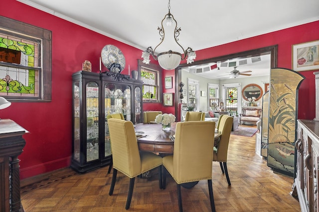 dining room featuring a ceiling fan, baseboards, and ornamental molding