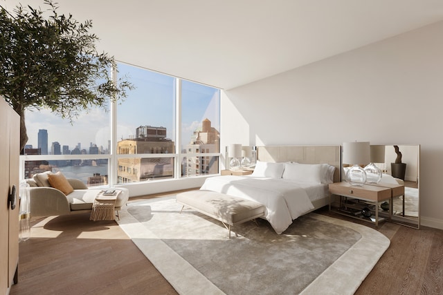 bedroom with a city view, baseboards, and wood finished floors