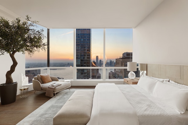 bedroom featuring a view of city and wood finished floors