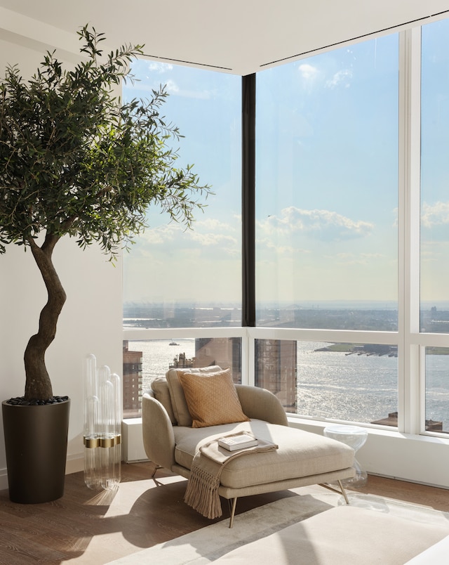 sunroom / solarium featuring a water view