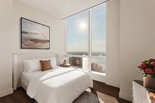 bedroom featuring dark wood-style flooring and baseboards