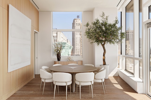 dining area with a city view and wood finished floors