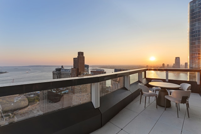 balcony at dusk with a view of city