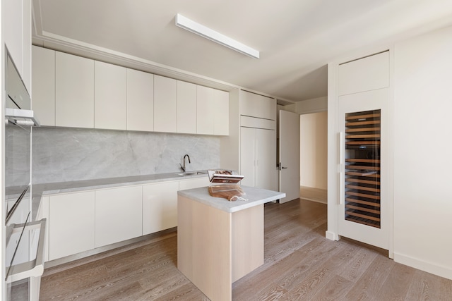 kitchen featuring light countertops, modern cabinets, and light wood-style floors