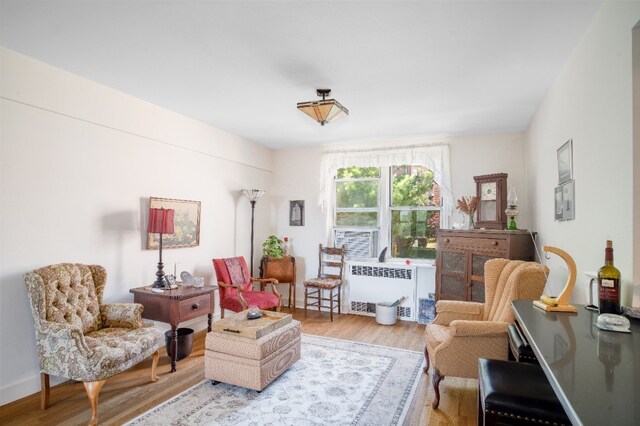 5650 Netherland Ave Unit 1A, New York City, NY 10471 - sitting room featuring radiator heating unit and wood finished floors