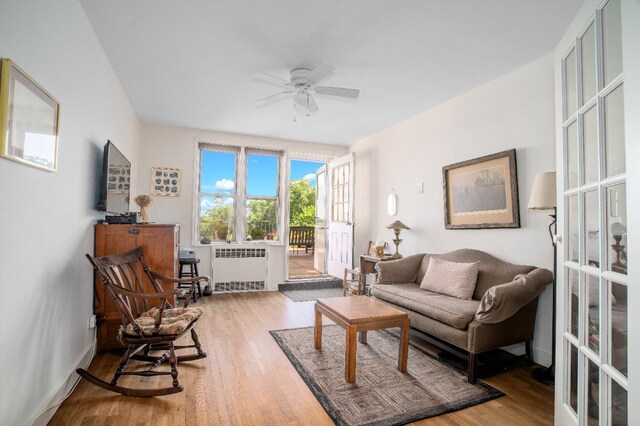 5650 Netherland Ave Unit 1A, New York City, NY 10471 - living room featuring wood finished floors, a ceiling fan, and radiator heating unit