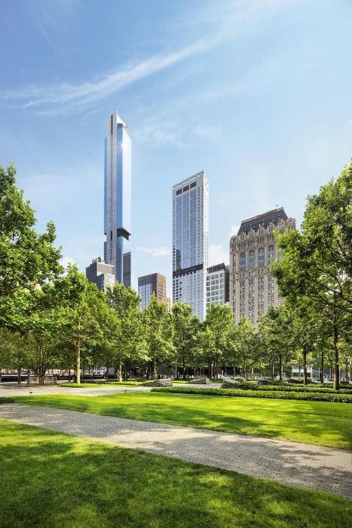 view of property's community featuring a view of city and a lawn