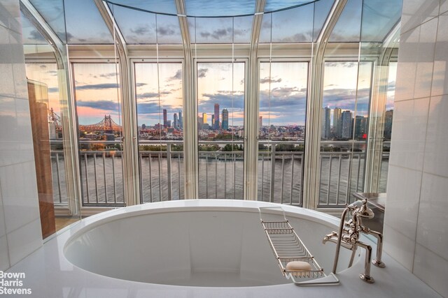 60 Sutton Pl S Unit Ph19S, New York City, NY 10022 - unfurnished sunroom featuring a water view and a city view