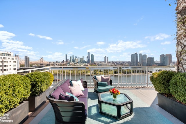 view of patio / terrace featuring an outdoor living space, a balcony, and a water view