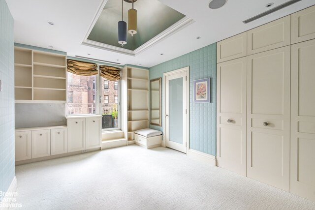 60 Sutton Pl S Unit Ph19S, New York City, NY 10022 - unfurnished bedroom with light carpet, a tray ceiling, crown molding, and a closet