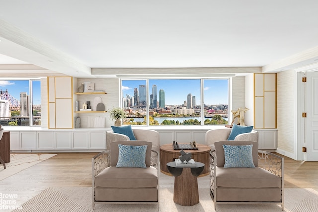 living area with a wealth of natural light and light hardwood / wood-style floors