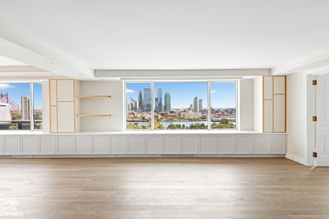 60 Sutton Pl S Unit Ph19S, New York City, NY 10022 - unfurnished room featuring a skyline view, light wood-style flooring, and healthy amount of natural light