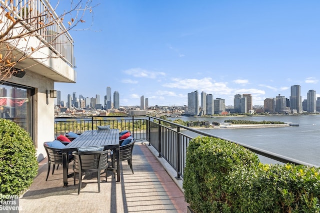 60 Sutton Pl S Unit Ph19S, New York City, NY 10022 - balcony with a view of skyline, a water view, and outdoor dining area