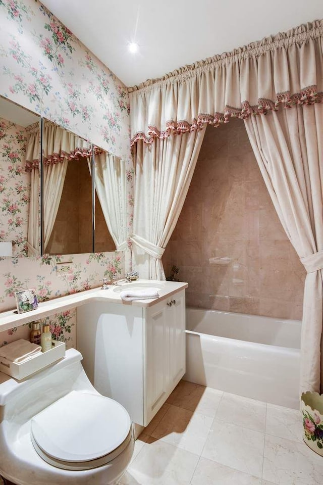 bathroom featuring vanity, tub / shower combination, wallpapered walls, and toilet