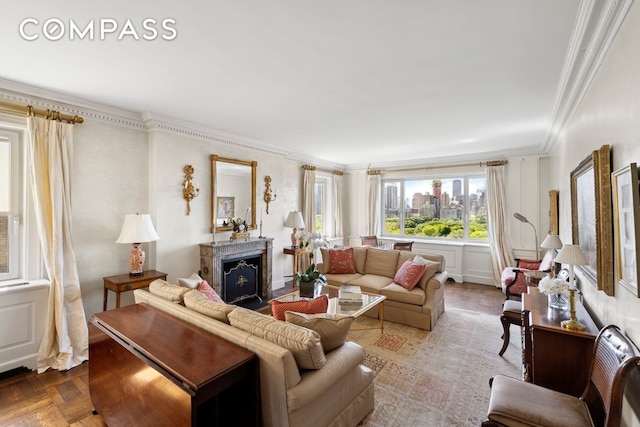 living room featuring a city view, crown molding, and a fireplace