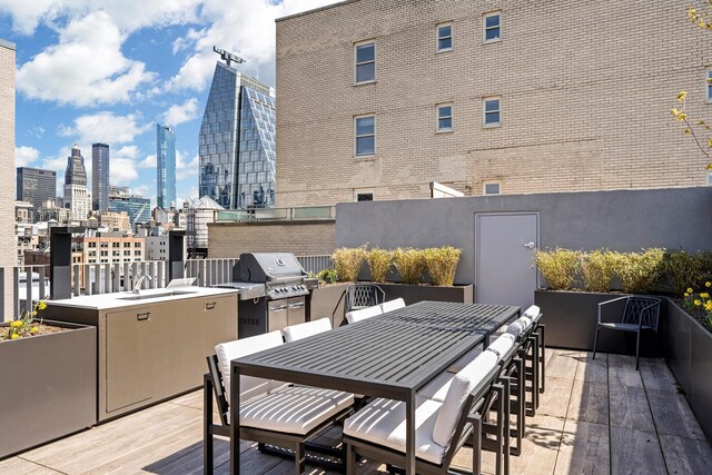 540 6th Ave Unit 11A, New York City, NY 10011 - wooden terrace with a grill, a skyline view, and outdoor dining space