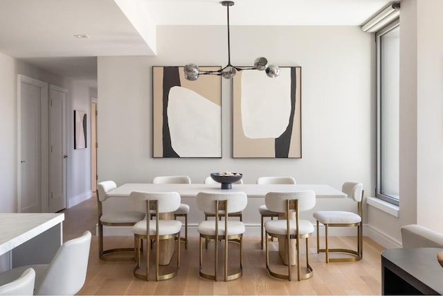 interior space with light wood-type flooring, a chandelier, and plenty of natural light