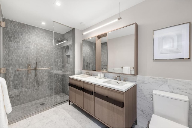 bathroom with walk in shower, vanity, tile walls, and toilet