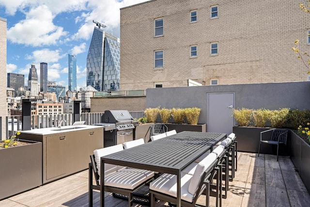 deck with a wet bar, a grill, and area for grilling