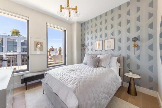 540 6th Ave Unit 11A, New York City, NY 10011 - bedroom with a chandelier and light wood-type flooring