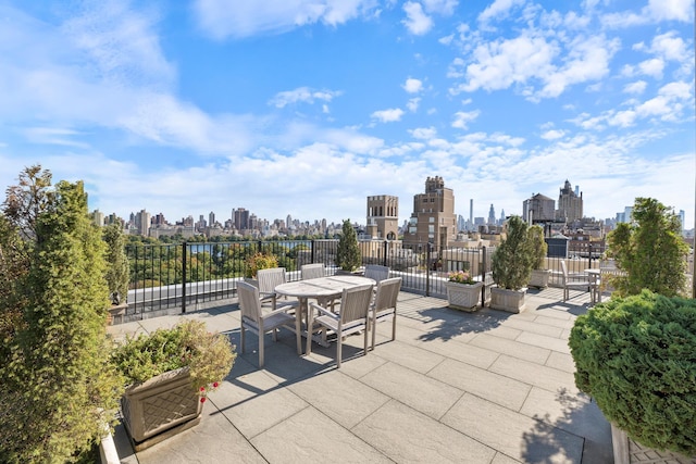 view of patio / terrace with outdoor dining space and a city view