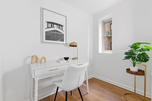 home office with light wood-style floors and baseboards