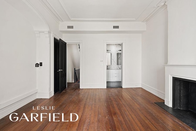 unfurnished living room with wood-type flooring, visible vents, a fireplace, and baseboards