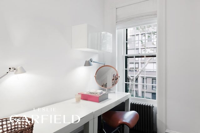 office featuring radiator and built in study area